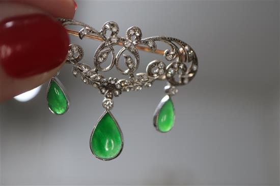 A 1920s yellow metal, diamond and jadeite set drop openwork scroll brooch, width 38mm.
